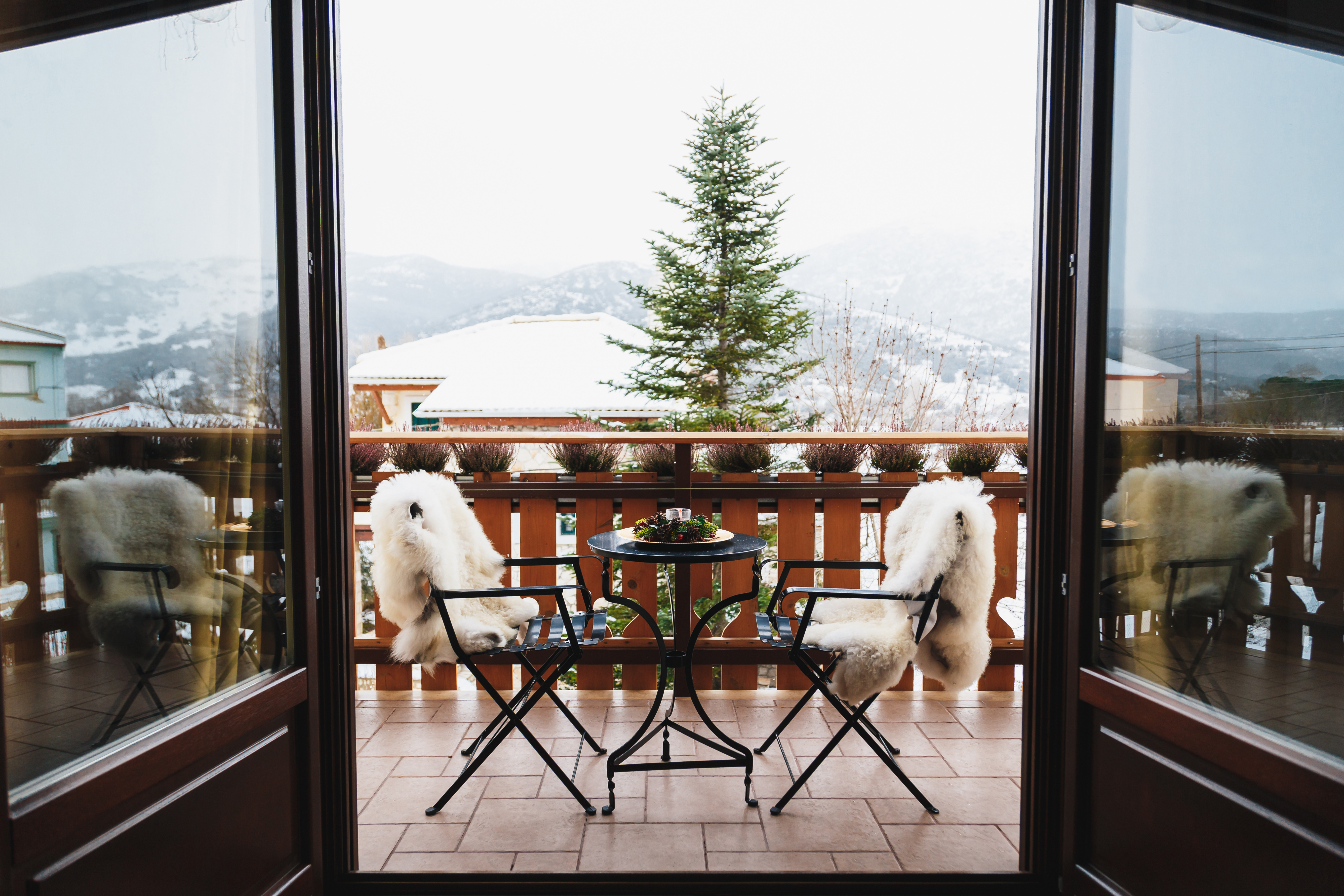Coffee on the top of a mountain with cozy chairs and a table